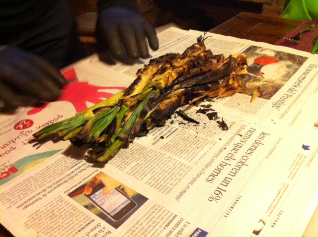 After the calçots are cooked they are wrapped in newspaper to "sweat" for a bit.  Note the heavy duty gloves that Jaume is wearing.  These babies are HOT!