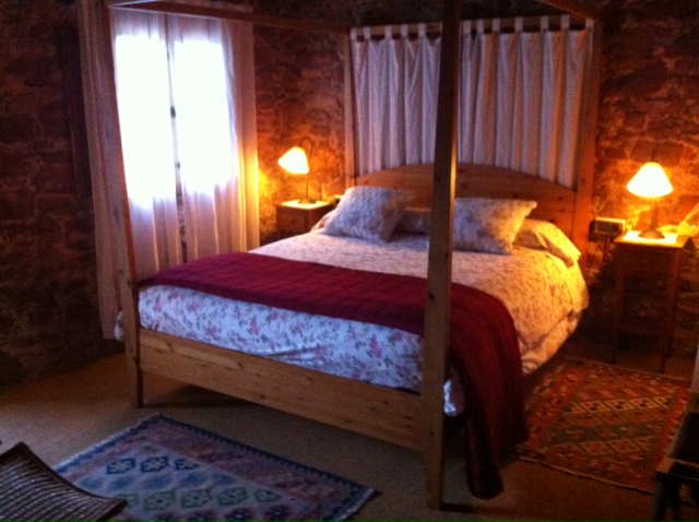 A bedroom at El Folló.  Cosy, rustic and very comfortable.