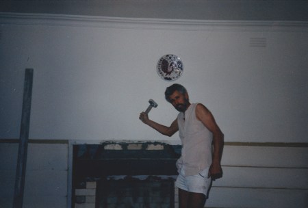 Rebuilding the fireplace was one of a zillion renovations he made to the house.  Also, check out that ceramic plate on the wall.  Do you see the bathos? 